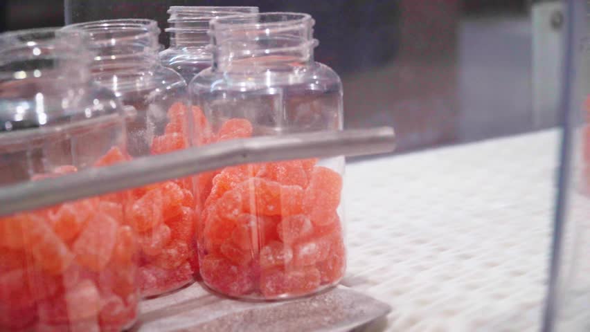 Nutraceutical vitamins supplements on the conveyor belt of the manufacturing industrial facility