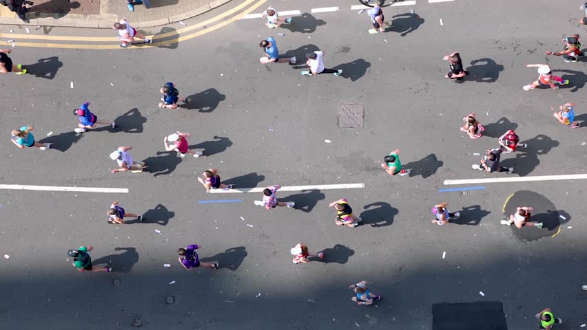 Aerial top view of marathon runners on a city street during a race