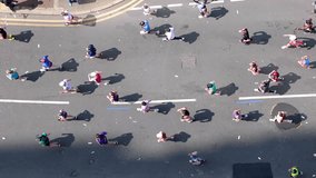Aerial top view of marathon runners on a city street during a race - Powered by Shutterstock - Get 15% off with code: PIKWIZARD15