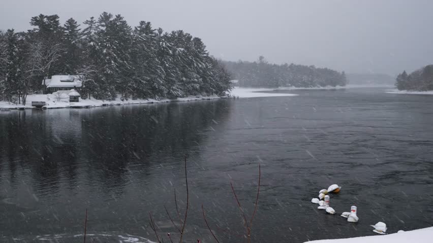 A beautiful landscape winter scene of a heavy snowfall midwinter on water at the Bala Falls in Muskoka