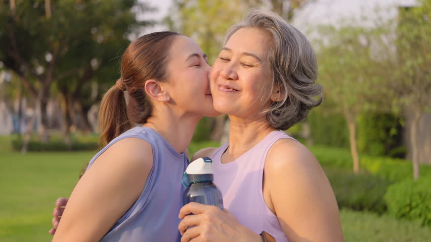 May Mother's day young adult child smile look at camera cuddle hug mature middle age old mum at outdoor green public park nature. Love kiss care mom asia elder people happy enjoy family aging life. - Powered by Shutterstock - Get 15% off with code: PIKWIZARD15
