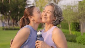 May Mother's day young adult child smile look at camera cuddle hug mature middle age old mum at outdoor green public park nature. Love kiss care mom asia elder people happy enjoy family aging life. - Powered by Shutterstock - Get 15% off with code: PIKWIZARD15