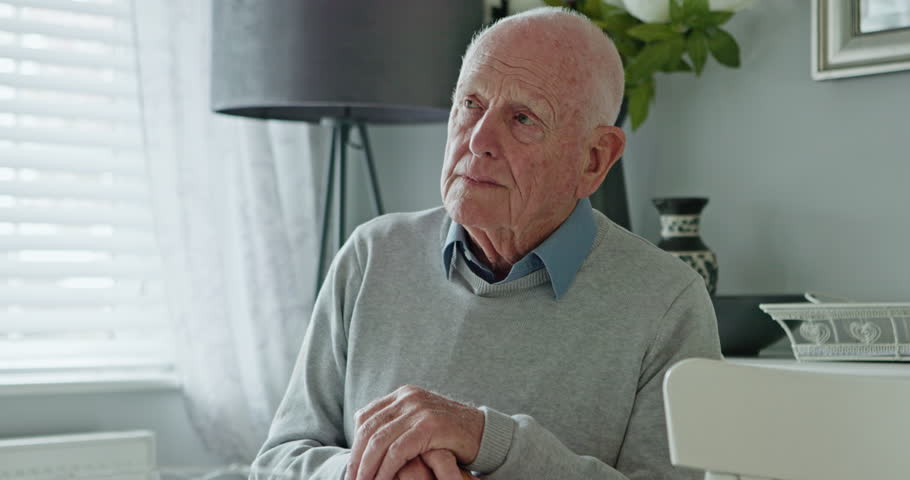 Thinking, depression and senior man in a living room with memory loss, stress or Alzheimer. Overthinking, anxiety and face of lonely elderly male person in a house with nostalgia, fail or dementia