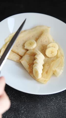 Crepes sweet banana slice syrup pancake breakfast dish dessert organic fresh tasty gourmet food background on the table rustic food top view copy space