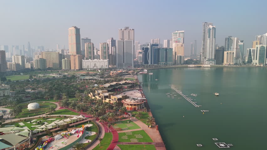 Sharjah, United Arab Emirates: Aerial view of capital city of Emirate of Sharjah, modern city skyline, financial district with skyscrapers - landscape panorama of Arabian Peninsula from above