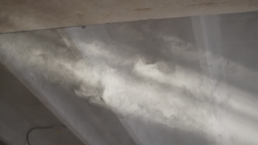 Soft sunbeams shining through dusty windows inside an abandoned industrial ambient.