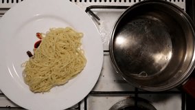 Mixing cooked boiled pasta with seasoning on a white plate, time lapse - Powered by Shutterstock - Get 15% off with code: PIKWIZARD15