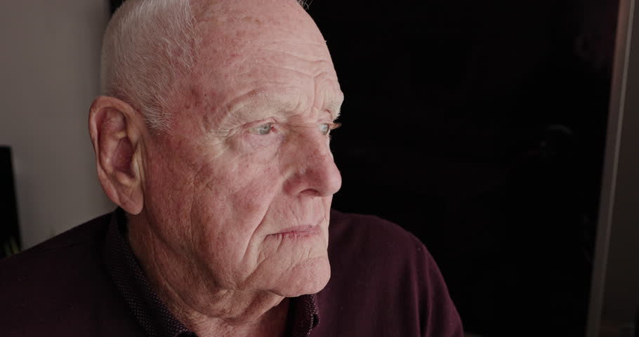Home, thinking and old man with depression, window and retirement with dementia, feeling lonely and alzheimer. Person with disability, senior guy and pensioner with anxiety, remember and memory