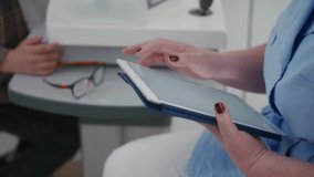 Close up of female doctor using digital tablet during medical consultation. Modern healthcare technology in use at the clinic, modern eye care - Powered by Shutterstock - Get 15% off with code: PIKWIZARD15
