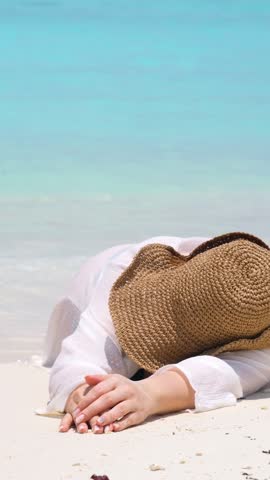 woman relax on summer resort, woman woman lying on sandy beach with a straw hat covering her face, resting peacefully by the sea, bright sunny island tropical atmosphere, vacation, summer happiness