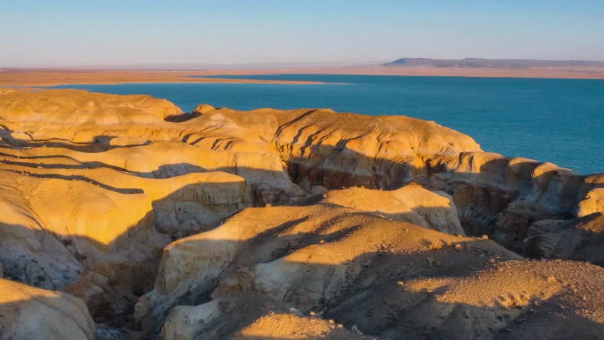 Aerial View of Desert Rock Formations and Lake