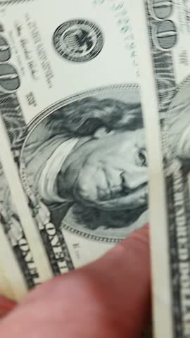 Close up of male hands counting money. Vertical video. Man counts dollar bills. Money calculation. Cash money payment. American currency exchange