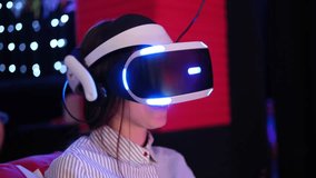 Girl wearing VR Glasses. Surprised teenager having fun play VR headset, virtual reality goggle, 3D cyber space. Futuristic neon blue red UV lighting. Digital technology, metaverse game, entertainment
 - Powered by Shutterstock - Get 15% off with code: PIKWIZARD15