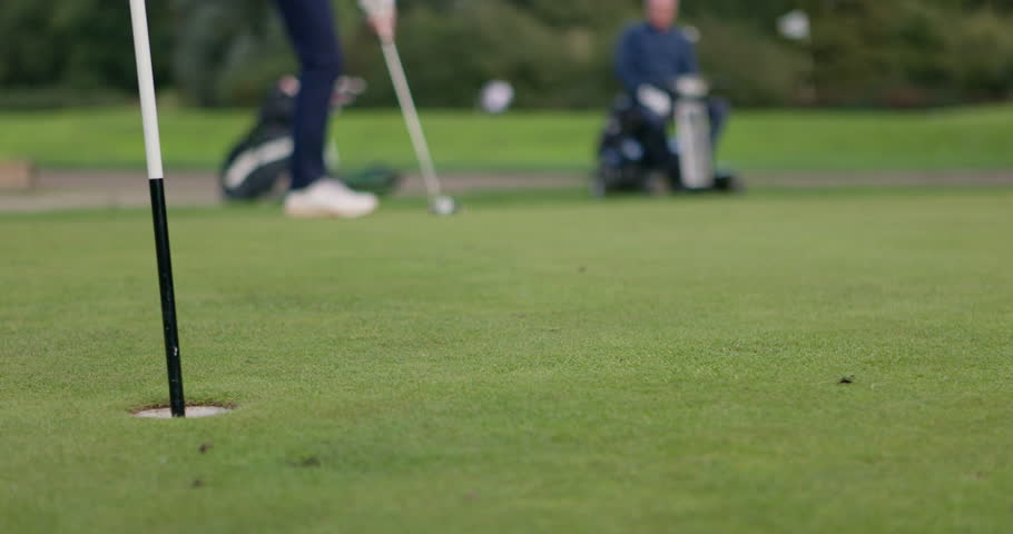 Feet, golf club and ball for shot on grass, pitch or course with training for competition, game or challenge. Para golfing, people or professional for sports by active with hobby, recreation or ready