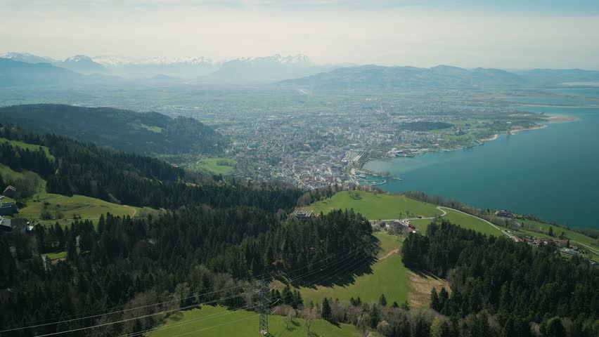 Picturesque view from mountain Pfaender in Bregenz, Austria on Lake Constance. Drone flying over mountain Pfander with lake Bodensee on horizon