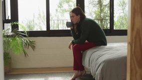 Woman sitting on edge bed in bedroom, with heart emojis floating around marketing campaign. Cozy, introspective, romantic, minimalist, tranquil, lifestyle, interior - Powered by Shutterstock - Get 15% off with code: PIKWIZARD15