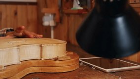 Woman carving wooden instrument body in workshop, showing education with floating heart icons. Craftsmanship, woodworking, artisanship, traditional, craft, hobby, vintage - Powered by Shutterstock - Get 15% off with code: PIKWIZARD15