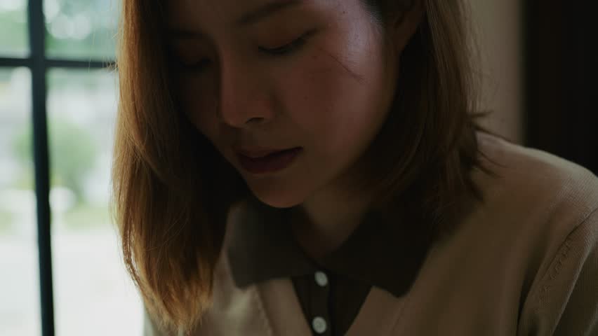 Close-up of a person holding open hands above an open Bible, symbolizing prayer, faith, humility, and spiritual surrender in peaceful reflection.