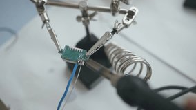 technician hands repairing circuit board with soldering iron. Extreme close-up of microelectronics components and precision soldering process. Concept of hardware diagnostics - Powered by Shutterstock - Get 15% off with code: PIKWIZARD15