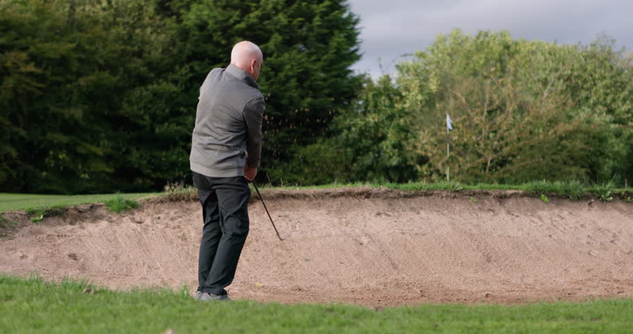 Golf course, sand trap and man swing in sport, game and exercise in retirement or summer vacation. Golfer, playing and training to develop sports stroke, hit or club ball onto grass, pitch or lawn