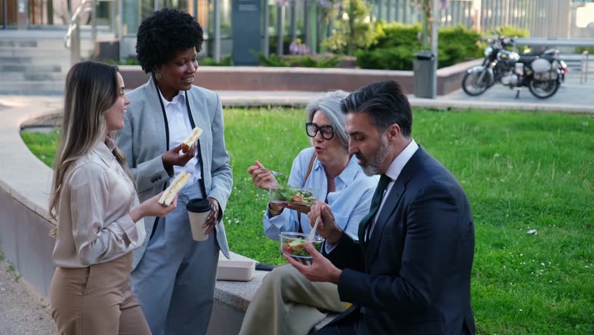 Business people eating salads and sandwiches during lunch break