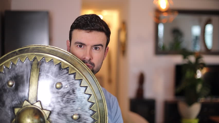 Adult man playing with medieval times sword and shield 