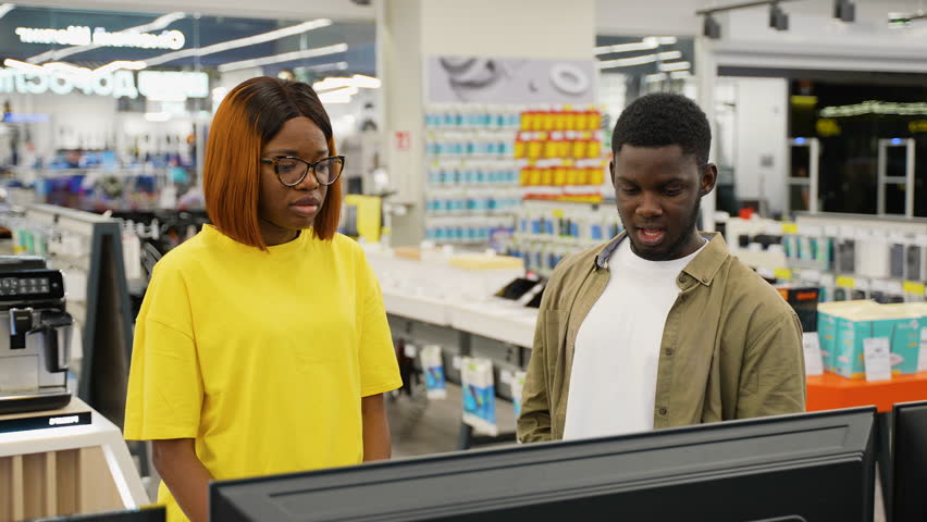 African American couple choosing a new TV in electronics store - Powered by Shutterstock - Get 15% off with code: PIKWIZARD15