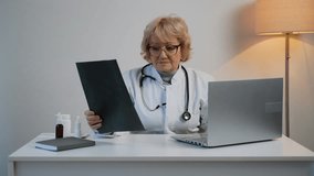 Senior female doctor analyzing X-ray scan in clinic - Powered by Shutterstock - Get 15% off with code: PIKWIZARD15
