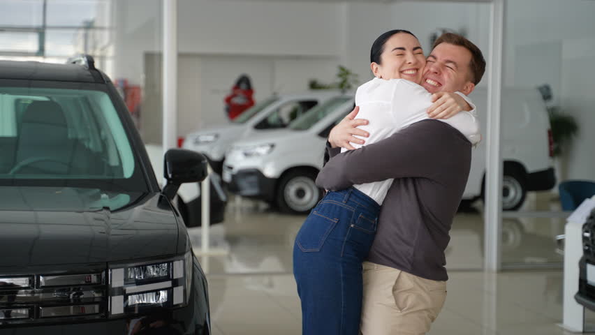 Man surprises woman with a new car at dealership