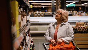 Senior Woman Buying Discounted Luxury Wine in Supermarket - Powered by Shutterstock - Get 15% off with code: PIKWIZARD15