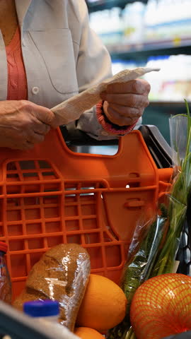 Close-Up of Senior Woman Checking Receipt in Grocery Store