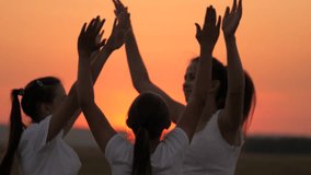 People dancing outdoors. Celebrate summer day at beach party. Girls are dancing cheerfully on summer evening. Cheerful teenagers having fun raise their hands up. Celebration in sunset. Silhouette - Powered by Shutterstock - Get 15% off with code: PIKWIZARD15