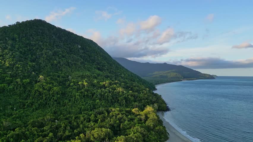 Sunset on beautiful tropical rainforest coastline in biodiverse Queensland Australia. High quality 4k footage