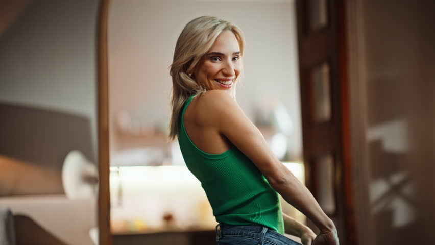 Slim figure trying old jeans closeup. Happy joyful girl enjoying weight loss dieting results. Attractive beautiful woman checking slimming progress looking mirror reflection. Well being motivation 