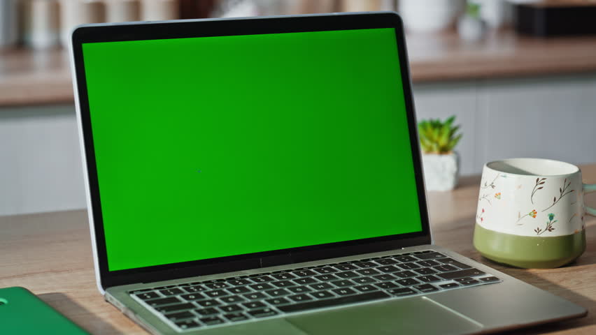 Woman finger pressing green screen laptop in kitchen closeup. Unknown lady managed touching button on chroma key device keyboard sending email. Freelancer working on mockup gadget at home workplace 