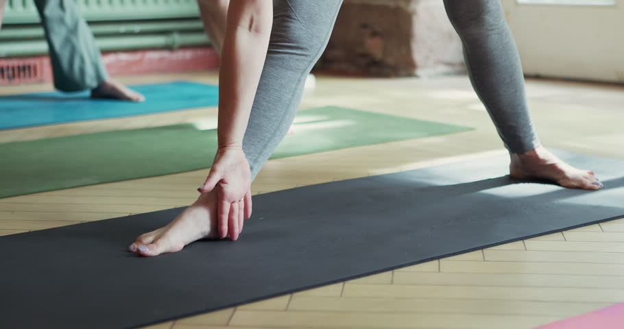 Leg stretching, woman and pilates with balance, workout and fitness warm up in a yoga studio or gym class. Wellness, mindfulness and female athlete with health and spiritual exercise with peace