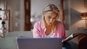 Online psychologist listening client by laptop video call at home closeup. Friendly blonde woman writing information in copybook looking computer webcam. Calm girl watching internet course at sofa - Powered by Shutterstock - Get 15% off with code: PIKWIZARD15