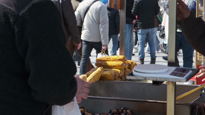 street vendor selling corn and chestnuts