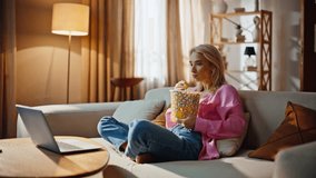 Focused lady viewing thriller movie snacking on chips at bright flat. Concentrated girl absorbed in dramatic scene cinema at comfy couch. Worried woman enjoying tensed series feeling involved on sofa - Powered by Shutterstock - Get 15% off with code: PIKWIZARD15