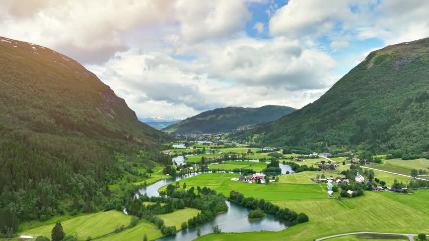 Aerial of a river winding through meadows and farmland near the town of Stryn Norway.