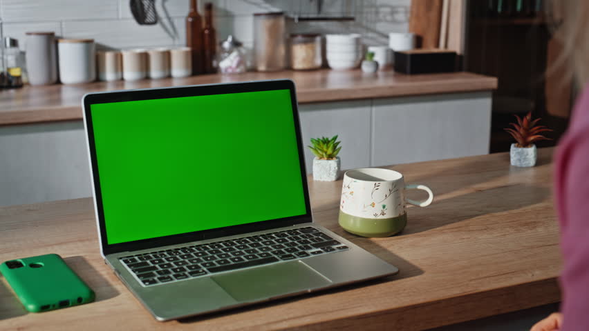 Student hands pressing chromakey laptop button at light room closeup. Busy woman arms using green screen device keyboard at kitchen. Unknown freelancer girl texting working mockup gadget alone indoors