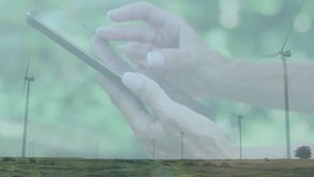 Woman using smartphone over rural wind farm, displaying floating graphs and stock tickers. Renewable energy, technology, sustainable, digital, eco-friendly, environmental, innovation - Powered by Shutterstock - Get 15% off with code: PIKWIZARD15