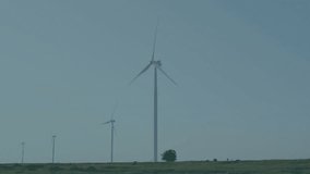 Wind turbines rotating over grassland blending with floating code overlay in flat design. Sustainability, renewable, digital, futuristic, landscape, technology, ecological - Powered by Shutterstock - Get 15% off with code: PIKWIZARD15