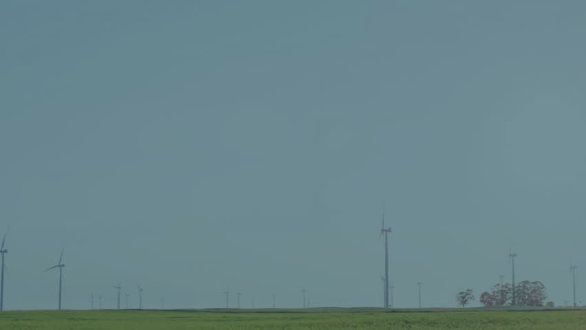 Financial stock chart overlaying rural landscape featuring candlesticks line graphs wind turbines. Technology, sustainability, finance, environment, innovation, horizon, growth - Powered by Shutterstock - Get 15% off with code: PIKWIZARD15