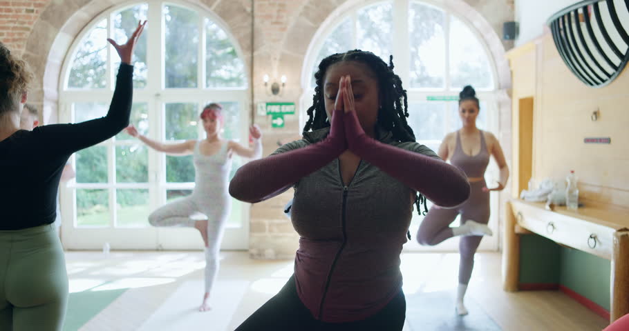 Yoga, peace and health with black woman in class for learning, fitness and mindfulness. Balance, meditation and wellness with person and workout in pilates studio for coaching, energy and spiritual