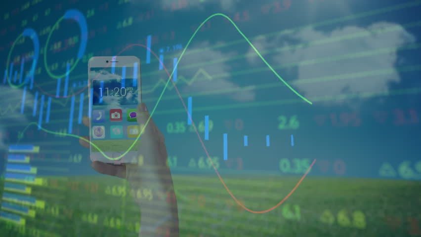 Hand holding smartphone showing weather widget overlaying finance charts with 3D cubes on field. Technology, outdoor, data visualization, digital, landscape, analytics, innovation