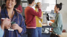 Coworkers sharing break in open-plan business office, using VR headset and showing floating emojis. Collaboration, innovation, teamwork, casual, modern, digital, connectivity - Powered by Shutterstock - Get 15% off with code: PIKWIZARD15