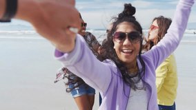 women taking selfie on sandy beach, with floating digital emoji icons for social media marketing. Diverse, friendship, outdoor, vibrant, cheerful, lifestyle, technology - Powered by Shutterstock - Get 15% off with code: PIKWIZARD15