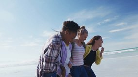 Four women walking arm-in-arm on beach, laughing while floating social media icons for marketing. Friends, camaraderie, leisure, outdoor, vibrant, joyful, lifestyle - Powered by Shutterstock - Get 15% off with code: PIKWIZARD15