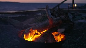 Relaxing flames in a firepit by the ocean at dusk near the beach - Powered by Shutterstock - Get 15% off with code: PIKWIZARD15
